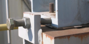 A jacking bolt (push bolt) on a motor in a refinery